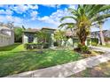 House exterior showcasing a landscaped yard and a two-car garage at 2005 Wexford Green Dr, Valrico, FL 33594