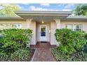 Charming home entrance with brick walkway and lush green bushes at 216 21St Ne Ave, St Petersburg, FL 33704