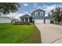 Two-story home with a two-car garage and landscaped lawn at 2291 Bolzano Ct, Land O Lakes, FL 34639