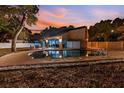 Night view of a refreshing pool with surrounding patio and landscape at 2735 Park N St, St Petersburg, FL 33710