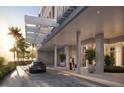 Modern building exterior with porte cochere and luxury vehicles at 2910 W Barcelona St # Ph-2303, Tampa, FL 33629