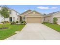 Two-story house with a two-car garage, and a green lawn at 3304 Suncoast Plains Dr, Odessa, FL 33556