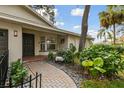 Landscaped front yard with a brick walkway and decorative plants at 356 Grand Central Ave, Safety Harbor, FL 34695