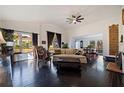 Spacious living room with dark hardwood floors, a fireplace, and a view of the dining area at 400 22Nd Ne Ave, St Petersburg, FL 33704