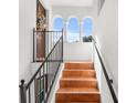 Exterior terracotta tile staircase with black metal railings leading to condo entrance at 418 S Albany Ave, Tampa, FL 33606