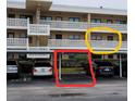 Condo building with parking and a view of a condo balcony at 4920 Locust Ne St # 203, St Petersburg, FL 33703