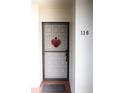 Inviting front door of home #116, enhanced with a festive heart decor at 6158 Palma Del Mar S Blvd # 116, St Petersburg, FL 33715