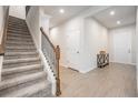 Bright entryway with carpeted stairs and tile flooring at 7878 Greenway Ave, Wesley Chapel, FL 33544