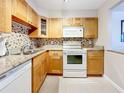 Well-equipped kitchen with wood cabinets and granite countertops at 7930 Sun Island S Dr # 305, South Pasadena, FL 33707