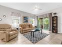 Light and airy living room with reclining sofas and access to balcony at 8332 Enclave Way # 101, Sarasota, FL 34243