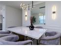 Modern dining room with marble table and stylish chairs at 9228 Forge Breeze Loop Loop, Wesley Chapel, FL 33545