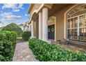 Front porch with columns, a bench, and potted plants at 9232 Brindlewood Dr, Odessa, FL 33556