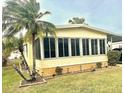 Side view of a yellow single-wide manufactured home with landscaping at 9790 66Th N St # 425, Pinellas Park, FL 33782