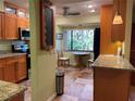 Eat-in kitchen, granite counters, wood cabinets, view to backyard at 103 Old Mill Pond Rd, Palm Harbor, FL 34683