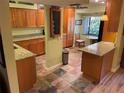 Bright kitchen with granite countertops and wood cabinets at 103 Old Mill Pond Rd, Palm Harbor, FL 34683