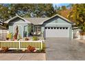 Quaint light blue house with a gray garage and nicely landscaped yard at 1030 Charles St, Clearwater, FL 33755