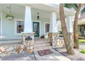 Inviting front porch with stone columns and a blue door at 1039 10Th N St, St Petersburg, FL 33705