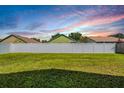 Large grassy backyard bordered by a white vinyl fence at 122 Orange Bud Way, Plant City, FL 33563