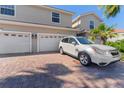 Charming two-story home with three-car garage and brick paver driveway at 1264 Riserva Ln, Palm Harbor, FL 34683