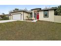 Brand new house with red front door and attached garage at 15958 Adobe Dr, Hudson, FL 34667