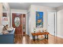 Bright and airy entryway with hardwood floors and unique decor at 1809 Wolf Laurel Dr, Sun City Center, FL 33573