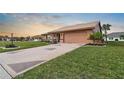 Front view of a single-story house with a geometric driveway at 1809 Wolf Laurel Dr, Sun City Center, FL 33573