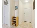 Bright condo entryway with tiled floors and a shoe rack at 18402 Bridle Club Dr # 18402, Tampa, FL 33647