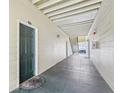 Condo hallway with light walls, a dark-green door, and a tiled floor at 18402 Bridle Club Dr # 18402, Tampa, FL 33647