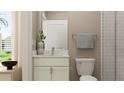 Small bathroom with white vanity, toilet, and shower at 18412 Serene Lake Loop, Lutz, FL 33548