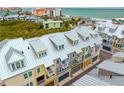 Aerial view of townhouses near the beach with metal roofs and balconies at 19915 Gulf Blvd # 303, Indian Shores, FL 33785