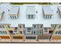 Aerial view of the rooftops of a row of townhouses with dormers and balconies at 19915 Gulf Blvd # 303, Indian Shores, FL 33785