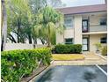 Condo building with lush green landscaping and parking at 2750 E Bay Dr # 1E, Largo, FL 33771