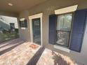 Front door entrance with navy blue door and sidelights at 28489 Tranquil Lake Cir, Wesley Chapel, FL 33543