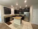 Modern kitchen with stainless steel appliances and island at 28489 Tranquil Lake Cir, Wesley Chapel, FL 33543
