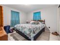 Cozy bedroom with a queen-size bed and teal bedding at 3303 Bainbridge Dr, Holiday, FL 34691