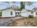 Light blue house with a one car garage, and mature trees at 3510 Dellefield St, New Port Richey, FL 34655