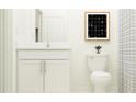 Small bathroom with white vanity, toilet, and shower at 35234 Gravelly Dr, Zephyrhills, FL 33541