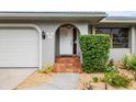 Home's entrance with tiled steps and landscaping at 3560 Tripoli Blvd, Punta Gorda, FL 33950