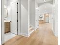 Inviting hallway featuring hardwood floors, a powder room, and an archway leading to the kitchen at 3640 15Th N St, St Petersburg, FL 33704