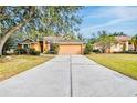 Two-story house with a large driveway and mature trees at 4020 Concord Way, Plant City, FL 33566
