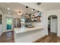 Modern kitchen with white cabinets, marble countertops, and stainless steel appliances at 436 Norfolk St, Dunedin, FL 34698