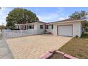 Brick driveway and garage with white exterior at 600 30Th N St, St Petersburg, FL 33713