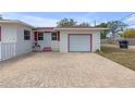 White garage with brick paver driveway at 600 30Th N St, St Petersburg, FL 33713