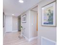 Bright hallway with light flooring, framed art, and a small accent table at 7600 Sun Island S Dr # 804, South Pasadena, FL 33707