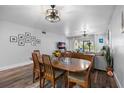 Dining area with wood table and chairs, adjacent to the living room at 8703 Bardmoor Blvd # 106, Seminole, FL 33777