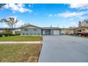 Newly painted light blue house with a 1-car garage and manicured lawn at 9100 52Nd N Way, Pinellas Park, FL 33782