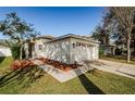 One-story home with a two-car garage and neatly landscaped front yard at 9607 Maxson Dr, Land O Lakes, FL 34638