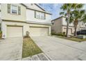 Two-story townhome with a two-car garage and driveway at 4762 White Sanderling Ct, Tampa, FL 33619