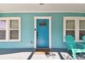 Bright blue front door adds a pop of color to the home's facade at 111 W Ida St, Tampa, FL 33603