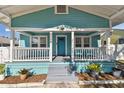 Inviting front porch with white railings and teal exterior at 111 W Ida St, Tampa, FL 33603